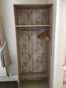 a walk in closet with a wooden cabinet at The Victoria guest house in Mablethorpe