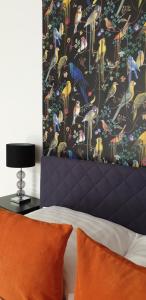 a bedroom with a bed with a colorful wallpaper at Grand Paradise Apartman in Miskolc