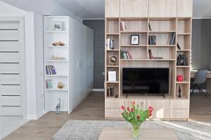 a living room with a large entertainment center with a tv at Panoramic Studio Oradea in Oradea
