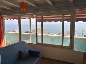 a room with a window with a view of the ocean at B&B Donna Sabella in Santa Flavia