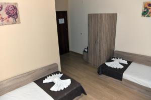 a hotel room with a bed and a desk at Twain Apart&Rooms in Sofia