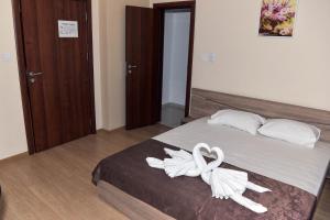a bedroom with a bed with white towels on it at Twain Apart&Rooms in Sofia