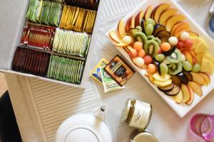 a table topped with a plate of fruits and vegetables at Trulli e Puglia Luxury Suite in Alberobello