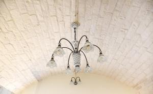 a chandelier is hanging from a ceiling at Trulli e Puglia Luxury Suite in Alberobello