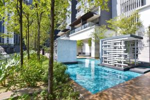a swimming pool in the middle of a building at Kisetsu no ie, KLCC Kuala Lumpur in Kuala Lumpur