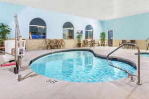 a swimming pool in a hotel with at Days Inn by Wyndham Pueblo in Pueblo