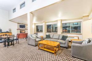 a living room with couches and a table at Days Inn by Wyndham Pueblo in Pueblo