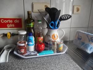 a tray with cooking utensils on a kitchen counter at Cantinho das Beiras in Praia da Vitória