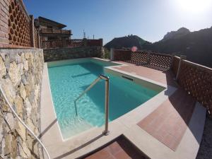 a swimming pool on the side of a building at Casa Ziretto in Castelmola