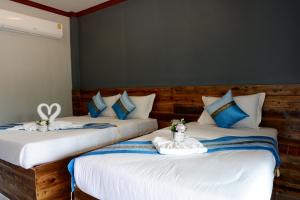dos camas sentadas una al lado de la otra en una habitación en Jarawee Resort, en Chumphon