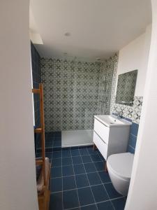 a bathroom with a toilet and a sink and a tub at La maison d'à côté in May-sur-Orne +22 photos