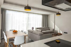 a living room with a couch and a table at Deluxe Apt w/ Rooftop Pool in The Heart of Kyrenia in Kyrenia