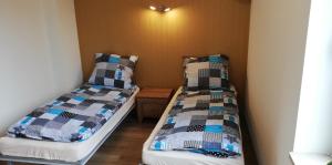 two beds sitting next to each other in a room at Lion Apartment in Andrychów