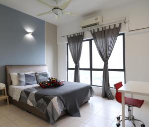 a bedroom with a bed and a large window at Family Apartment at Setia Walk Puchong near IOI Mall Puchong LRT Station in Puchong