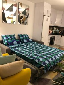 a bed in a living room with a kitchen at La Mata Beach - Studio - Appartement - Miramar XI - Torrevieja in Torrevieja