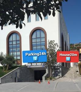 a building with two street signs in front of it at Apartment Geart in Berat
