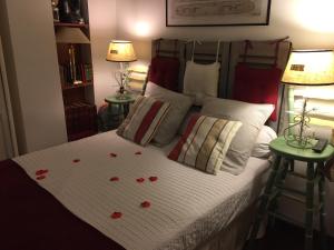 a bedroom with a bed with hearts on it at Chambre et salle de bain cocooning labellisée in Nice