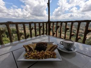 une assiette de nourriture sur une table avec une tasse de café dans l'établissement Valle Encantado, à San Isidro de El General