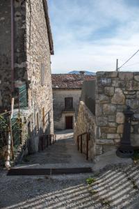 an alley in an old stone building with a gate at casa vacanze al paesello in Orezzo