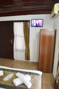a room with a bed and a window and a tv at Konak Hotel Kaleiçi in Antalya +114 photos