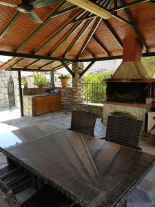 a table and chairs in a patio with a fireplace at Lemon Flowers Apartments in Nea Skioni +18 photos