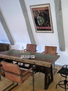 a dining room with a wooden table and chairs at Babette Apartments in Lübeck