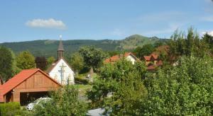 a small town with a church and a building at Rhön-Hotel Sonnenhof - in Poppenhausen
