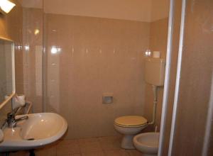 a bathroom with a sink and a toilet and a shower at Villaggio Accademia in Cesenatico