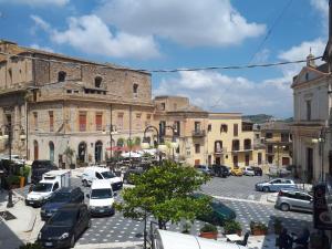 a city with cars parked in a parking lot at Casa Vacanza "La Chiazza di Grutti" in Grotte