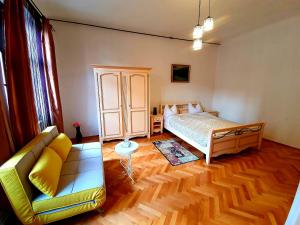 a living room with a bed and a couch at Maximus Apartments in Sighişoara +60 photos