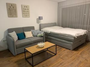 a living room with a couch and a coffee table at Apartment Beethoven by Aux Property in Augsburg