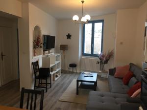 a living room with a couch and a table at Gîte du rocher in Le Puy-en-Velay