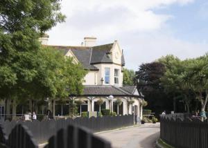 a white house with a fence in front of it at 36 Tudor Court, Tolroy Manor in Saint Erth