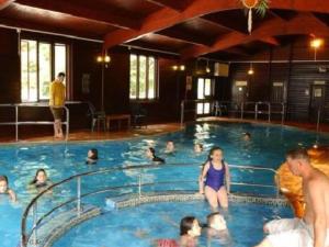 a group of people in a large swimming pool at 36 Tudor Court, Tolroy Manor in Saint Erth