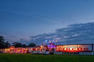 a building with cars parked in a parking lot at night at Vintage, Circus Holiday Home in Mablethorpe