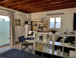 a kitchen with a white counter and a refrigerator at Loft La ISLA in Playa Blanca