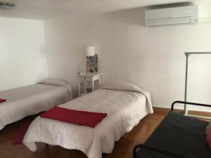 a room with two beds in a room at Casa Cardinho - A sua casa no Alentejo in Castelo de Vide