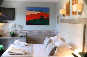 a bedroom with a bed and a painting on the wall at Casa Di Lucia Mi-Hotel in Mazzola +64 photos