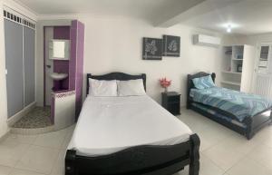 Cama o camas de una habitación en Posada Cocos Place
