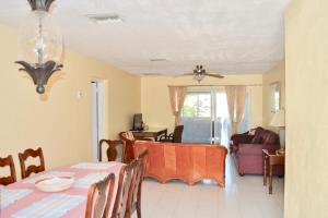 a dining room and living room with a table at Waterway Condos in Nassau