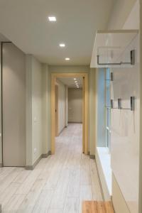an empty hallway of an office building with wood floors at casavacanza orchidea 2 in Bergamo +35 photos