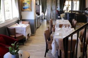 a dining room with white tables and chairs at Casa Di Lucia Mi-Hotel in Mazzola