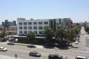 洛杉磯的住宿－花園套房酒店和度假勝地，一条城市街道,汽车停在大楼前