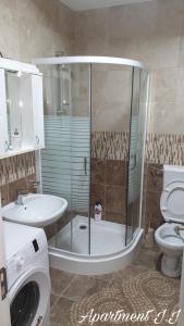 a bathroom with a shower and a toilet and a sink at Apartment J.J in Požarevac