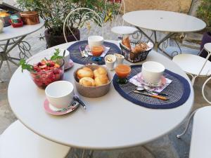a table with breakfast foods and cups on it at Parfumu Di Celu in Corte