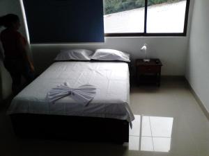 Postel nebo postele na pokoji v ubytování Hotel Shalom PHE Guaduas