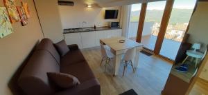 a living room with a couch and a table at DONJON SUITE centro storico in Castelbuono