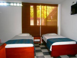 Postel nebo postele na pokoji v ubytování Hotel Shalom PHE Guaduas