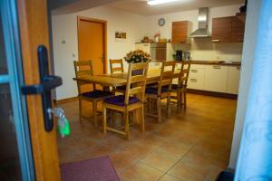 a kitchen with a dining room table and chairs at Gästehaus Schulz in Schenkendöbern