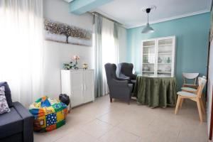 a living room with a table and two chairs at Casa Angel in Cáceres